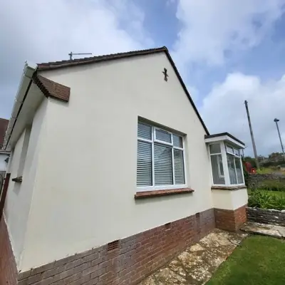 The same gable end after softwashing, render clean and even